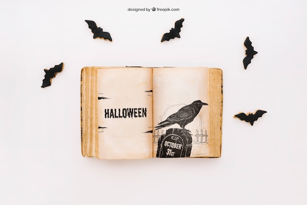 Mockup di halloween con libro e pipistrelli