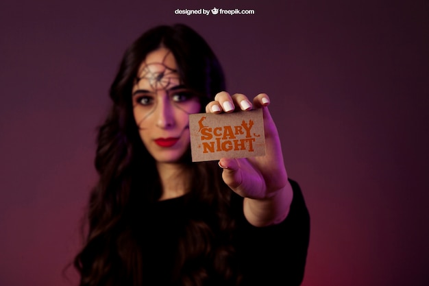 Halloween mockup with girl holding business card