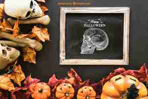 Free PSD halloween slate mockup with autumn leaves and skull