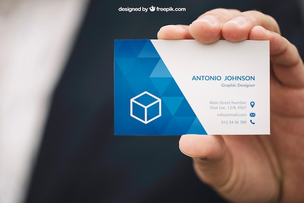 Hand holding business card mockup