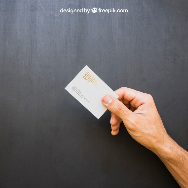 hand holding golden business card