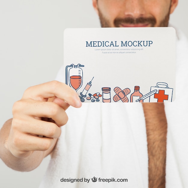 Free PSD hand holding medical mock up in foreground