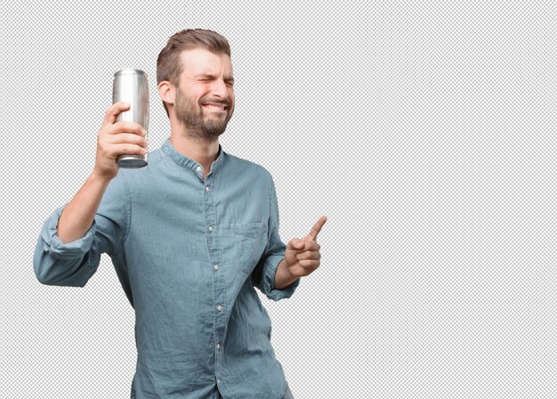 Handsome young man dancing with can