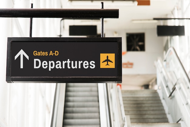 Hanging sign mockup in front of an escalator