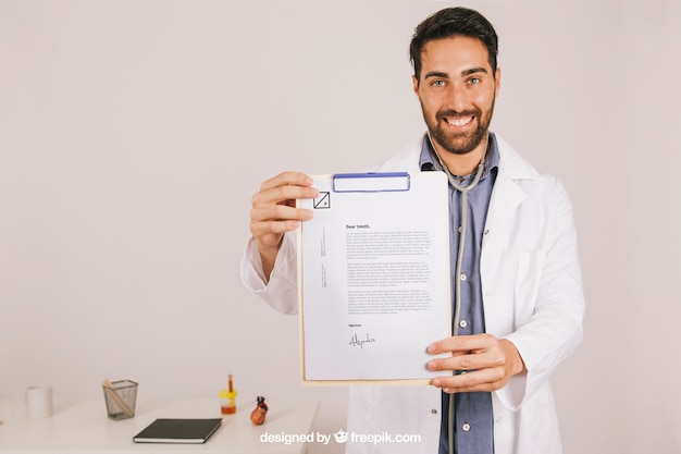 Happy doctor with clipboard in the clinic