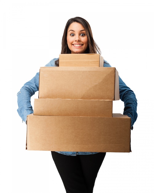 Happy girl holding cardboard boxes