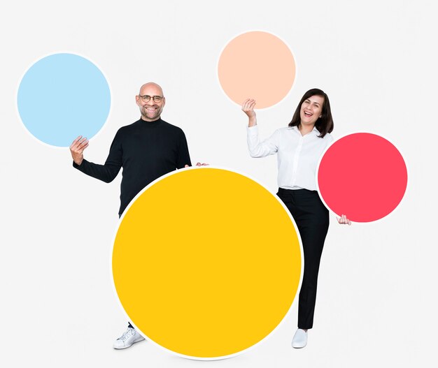 Happy people holding colorful round boards