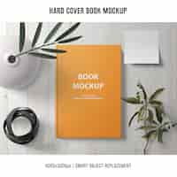 Free PSD hard cover book mockup with plants