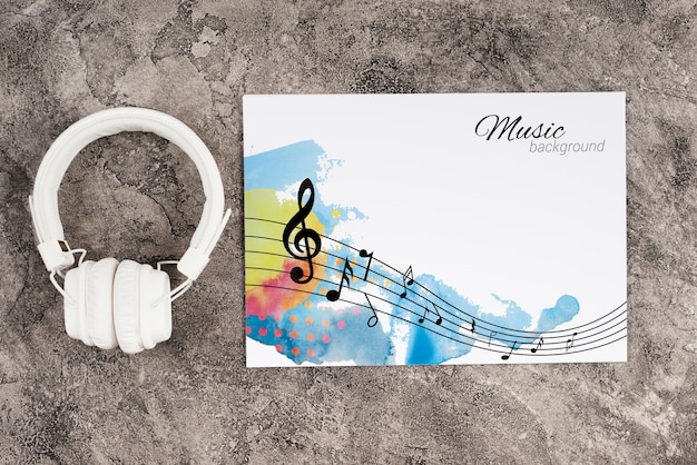 Headphones beside sheet with music concept