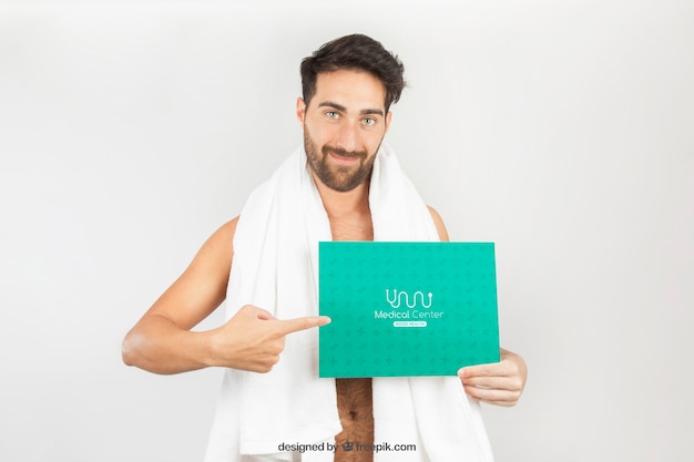Healthy man posing with towel andtemplate