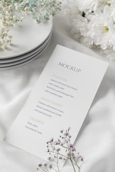 High angle of table arrangement with dishes and spring menu mock-up