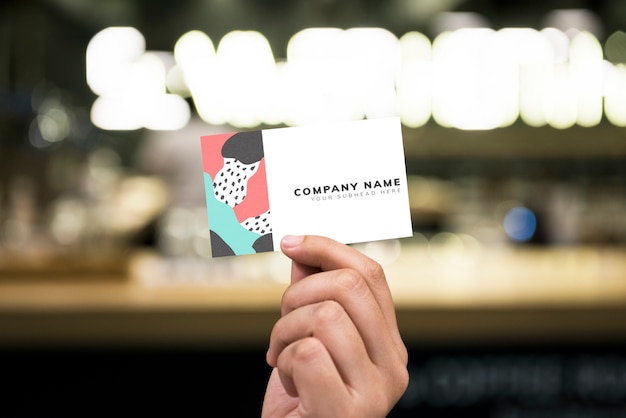 Holding up a business card mockup