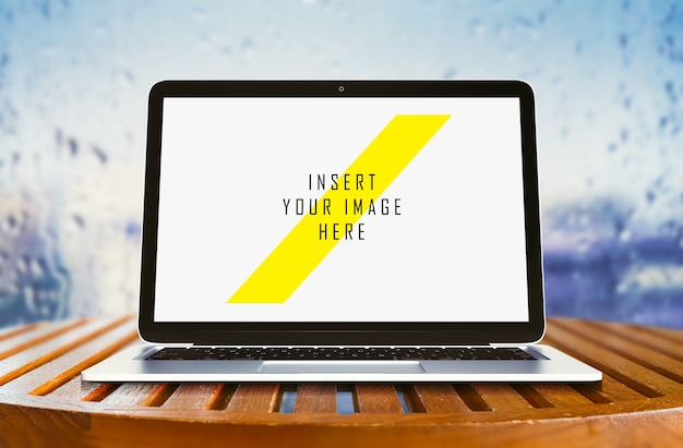 Laptop on wooden table mock up