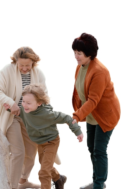 Little boy spending time outdoors with his grandmothers