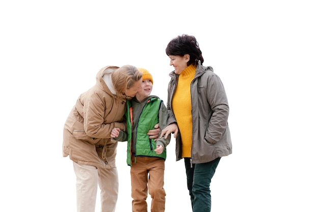 Little boy spending time outdoors with his grandmothers