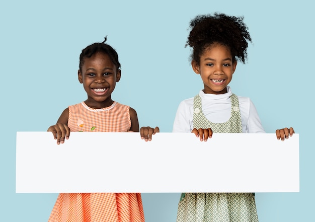 Little girl smiling and holding blank search placard