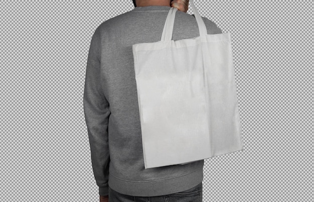 Free PSD male model holding a white tote bag on his back on transparent background