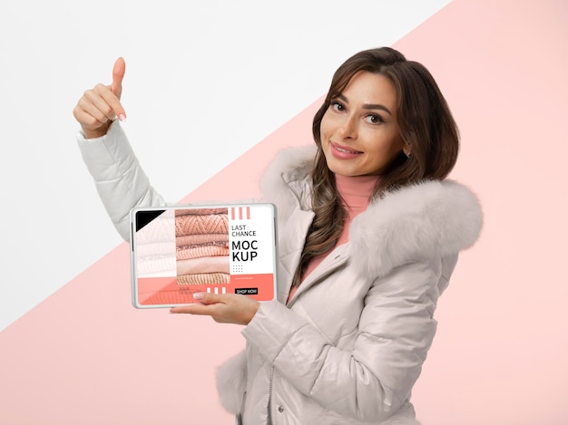 Medium shot smiley woman holding tablet Free Psd