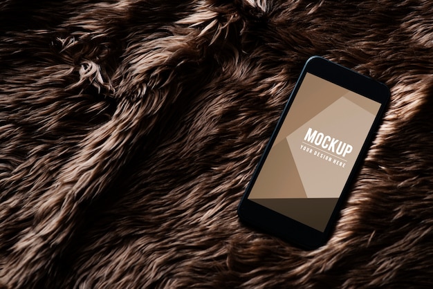 Free PSD mobile phone screen mockup on fur surface