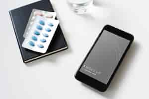 Free PSD mobile phone with pills on the table