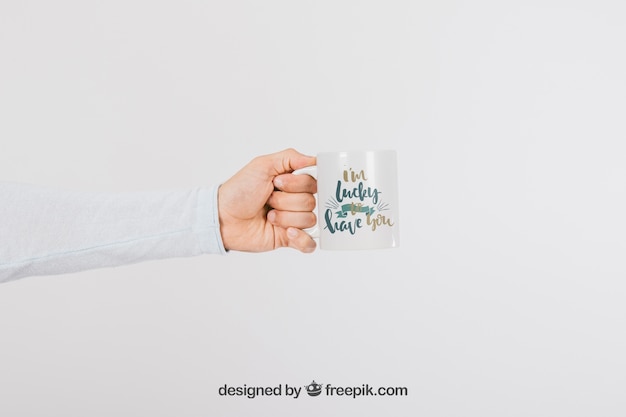 Free PSD mock up design of hand with mug