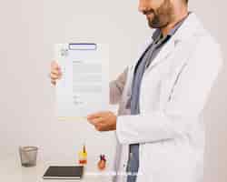 Free PSD mock up design with smiley doctor holding clipboard