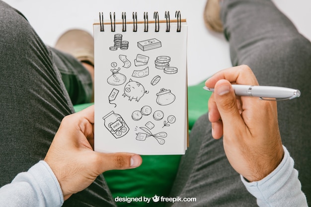 Free PSD mock up with hands drawing on the notebook