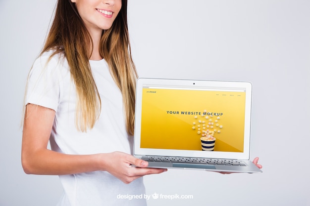 Free PSD mockup concept of woman holding laptop