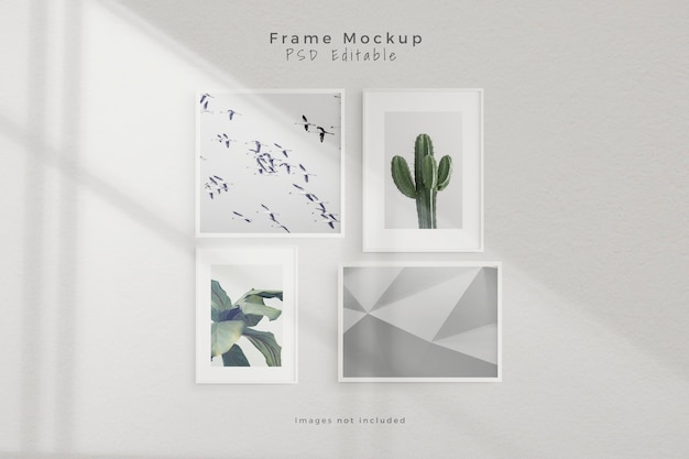 Free PSD mockup four empty photo frame mockup in empty white wall room