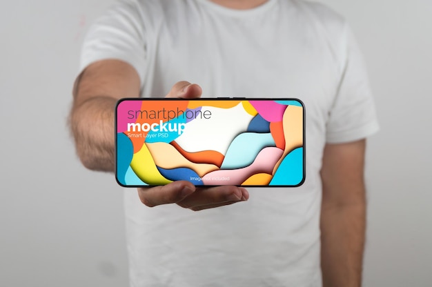 Mockup Of Man Holding A Smartphone