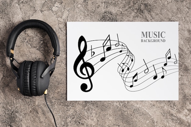 Music design on sheet with headphones beside