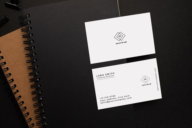 Notebooks and visiting card mockup with black element on black background