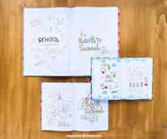 Free PSD notebooks with drawings on wooden table