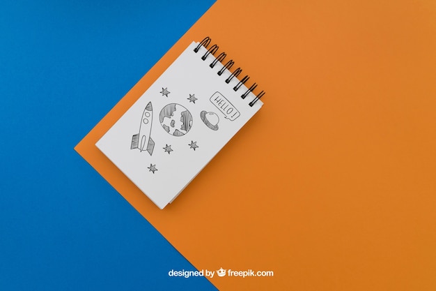 Notepad on blue and orange background