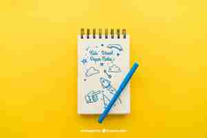 Free PSD notepad with pencil on yellow background