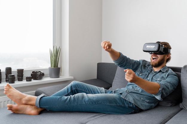 Person having fun at home with vr glasses mockup