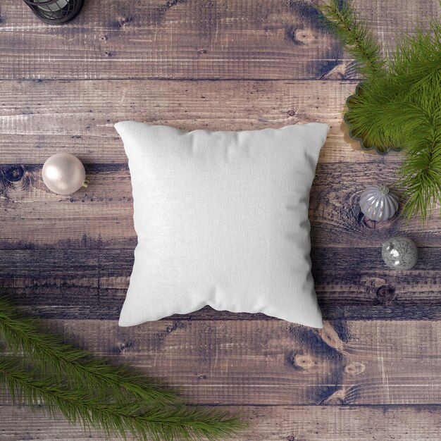 Pillow on a wooden table surrounded by baubles, pines and fir