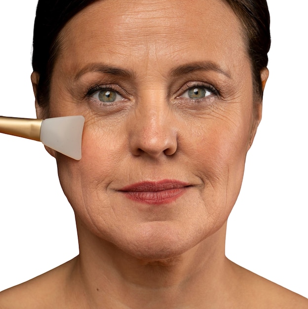 Portrait of senior woman with silicon brush for skincare