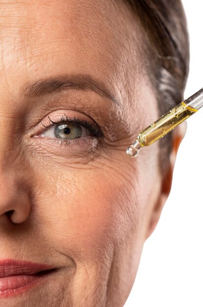 Portrait of senior woman with skin serum