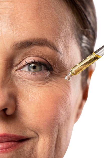Portrait of senior woman with skin serum