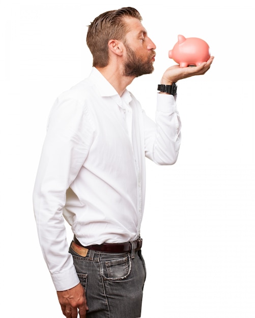 Romantic guy kissing his piggy bank