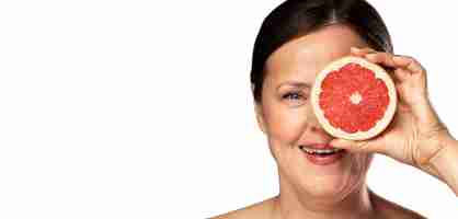 Free PSD senior woman with grapefruit for skincare