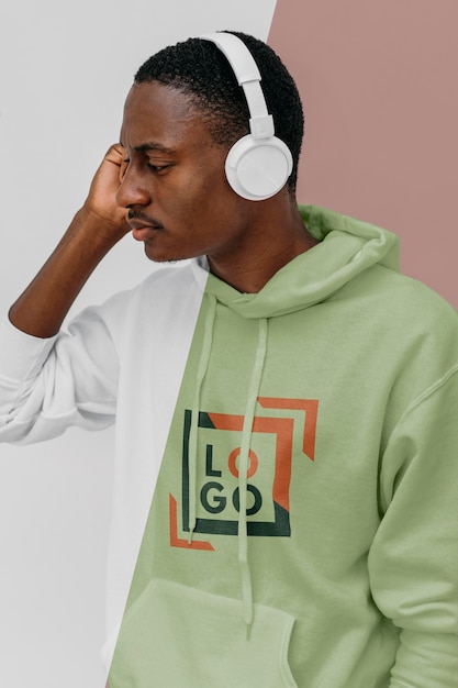 Side view of stylish man in hoodie with headphones