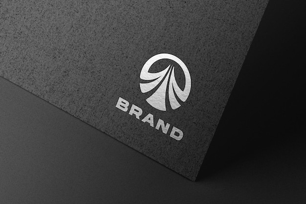 Silver logo mockup embossed on black paper