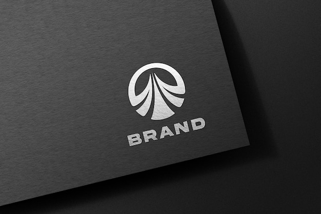 Silver logo mockup embossed on black paper