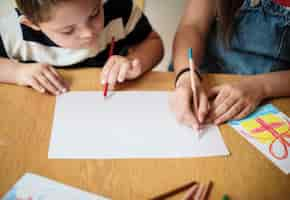 Free PSD sister and brother drawing at a table