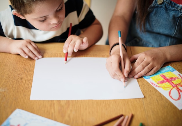 Sister and brother drawing at a table