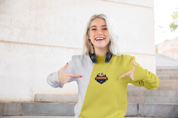 Smiley woman pointing at hoodie