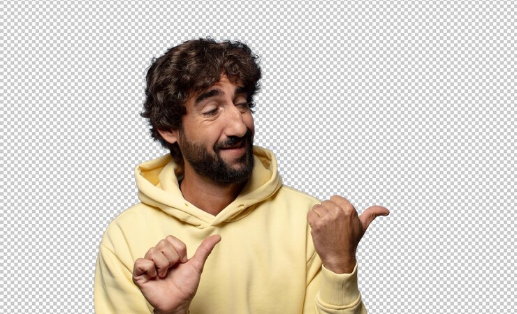 Free PSD smiling cheerfully and casually pointing to copy space on the side feeling happy and satisfied