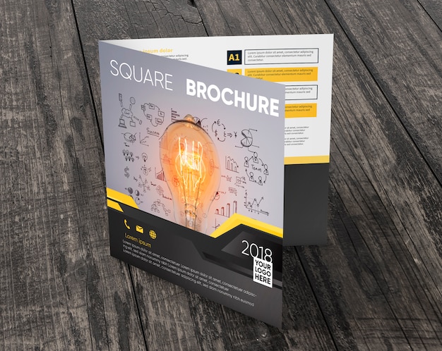 Square brochure mockup on wooden surface